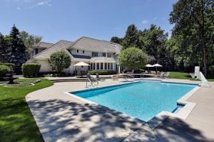 Baton Rouge pool deck with non-slip pavers and low-voltage step lights at dusk